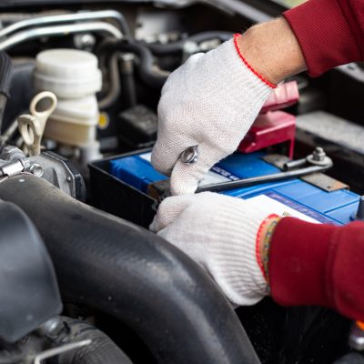 Car mechanic in the engine bay