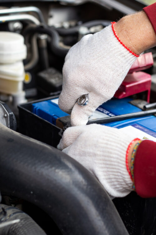 Car mechanic in the engine bay