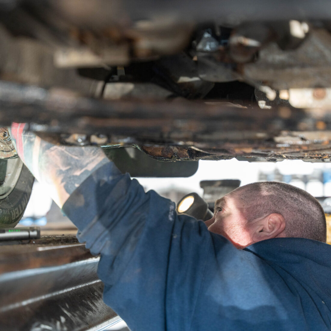 mechanic underneath a car